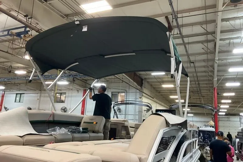 Slide: The Image of 2026 Bennington 24 M L-Bench boat assembly in factory setting. - 9