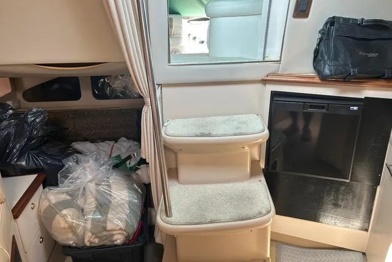 Slide: The Image of Interior of 2000 Cruisers Yachts 3575 Express with steps, storage, and compact fridge. - 12