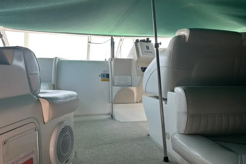 Slide: The Image of Interior of 2000 Cruisers Yachts 3575 Express with white seating and green canopy. - 5