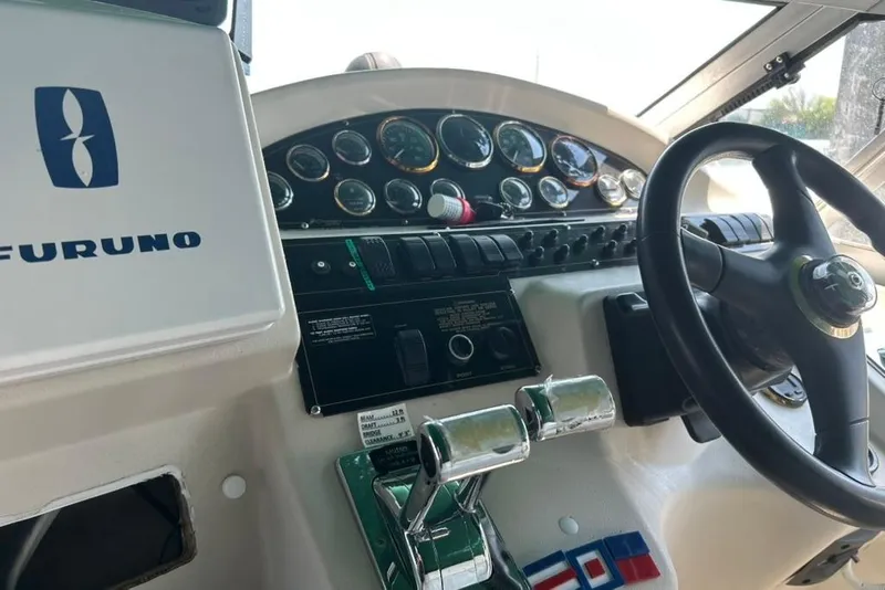 Slide: The Image of Cockpit of 2000 Cruisers Yachts 3575 Express with steering wheel and control panel. - 6