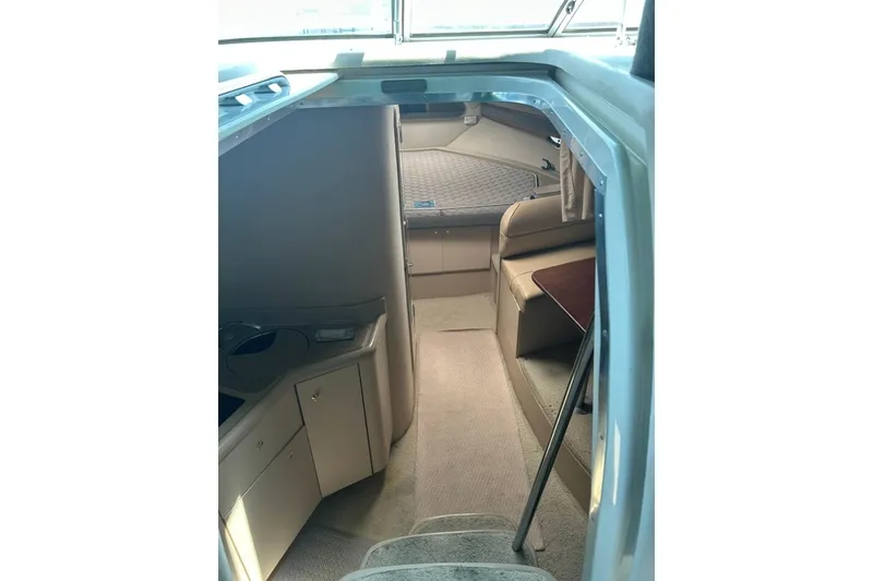 Slide: The Image of Interior view of 2000 Cruisers Yachts 3575 Express, featuring cozy cabin and seating area. - 8