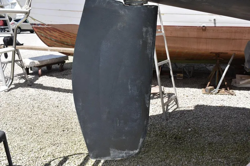 Slide: The Image of Catalina 310 sailboat keel, 2001 model, on dry dock with ladder nearby. - 11