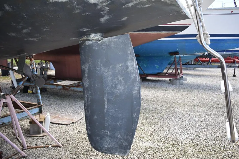 Slide: The Image of Catalina 310 sailboat rudder and propeller, 2001 model, on dry dock for maintenance. - 12