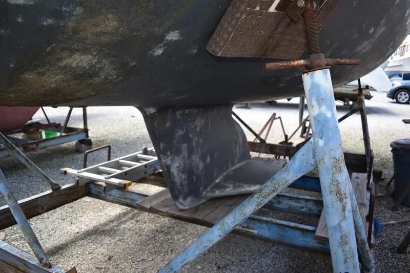 Slide: The Image of 2001 Catalina 310 sailboat keel on a metal stand in a boatyard. - 17