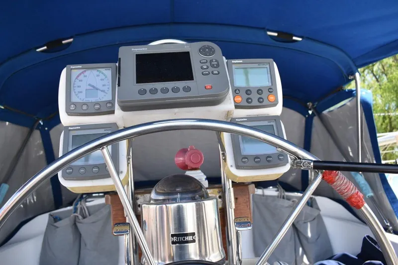Slide: The Image of Cockpit of 2001 Catalina 310 sailboat with navigation instruments and steering wheel. - 18