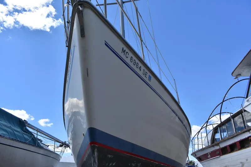 Slide: The Image of 2001 Catalina 310 sailboat on land, clear sky background. - 2