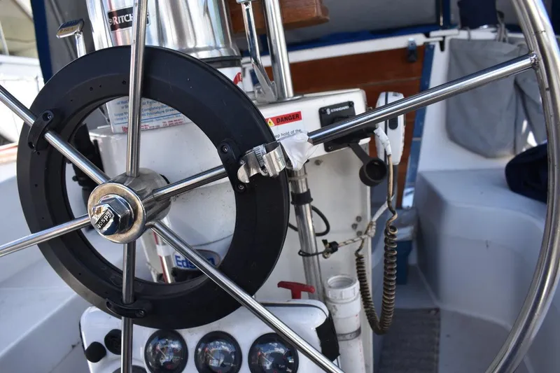 Slide: The Image of Steering wheel and controls of a 2001 Catalina 310 sailboat cockpit. - 22