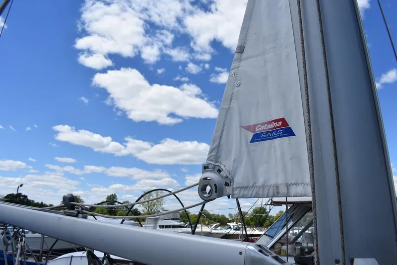 Slide: The Image of Sail of a 2001 Catalina 310 boat against a bright blue sky. - 25