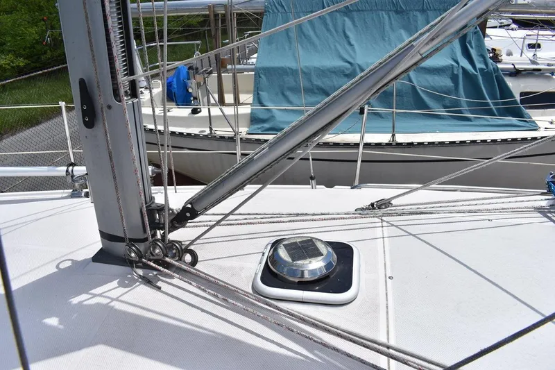 Slide: The Image of Deck view of a 2001 Catalina 310 sailboat, showcasing rigging and hatch details. - 26