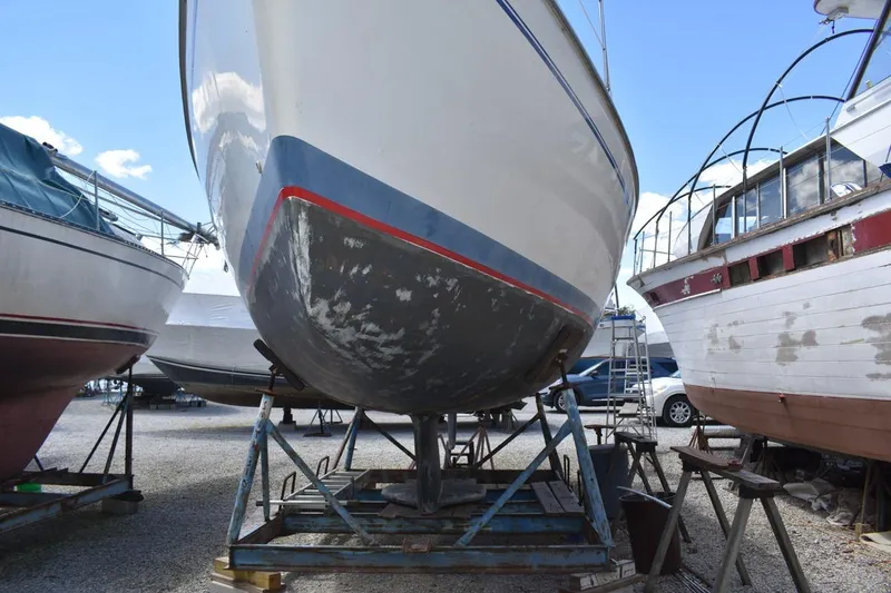 Slide: The Image of 2001 Catalina 310 sailboat on stands in a boatyard, undergoing maintenance. - 3