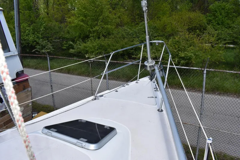 Slide: The Image of Bow view of a 2001 Catalina 310 sailboat, featuring deck and railing details. - 31