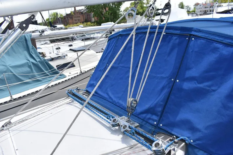 Slide: The Image of Sailboat rigging on a 2001 Catalina 310 with blue canvas cover. - 34