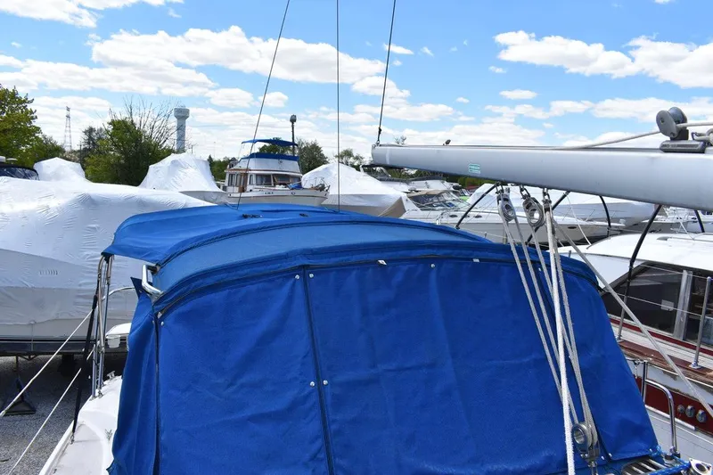 Slide: The Image of Catalina 310 sailboat, 2001 model, with blue cover in a marina setting. - 37