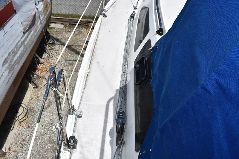 Slide: The Image of Catalina 310 sailboat deck with blue cover, 2001 model, docked outdoors. - 38