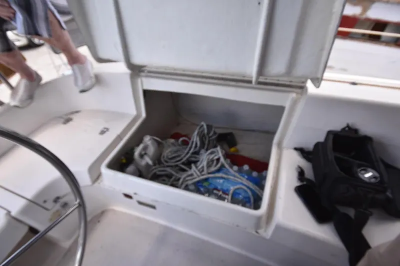 Slide: The Image of Open storage compartment on a 2001 Catalina 310 sailboat, containing ropes and supplies. - 41