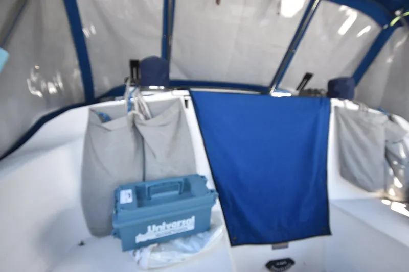 Slide: The Image of Interior of a 2001 Catalina 310 sailboat with blue and gray storage bags. - 42