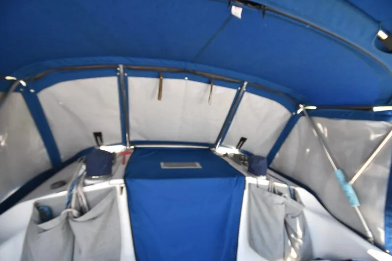 Slide: The Image of Interior view of a 2001 Catalina 310 sailboat with blue and gray canvas covers. - 43