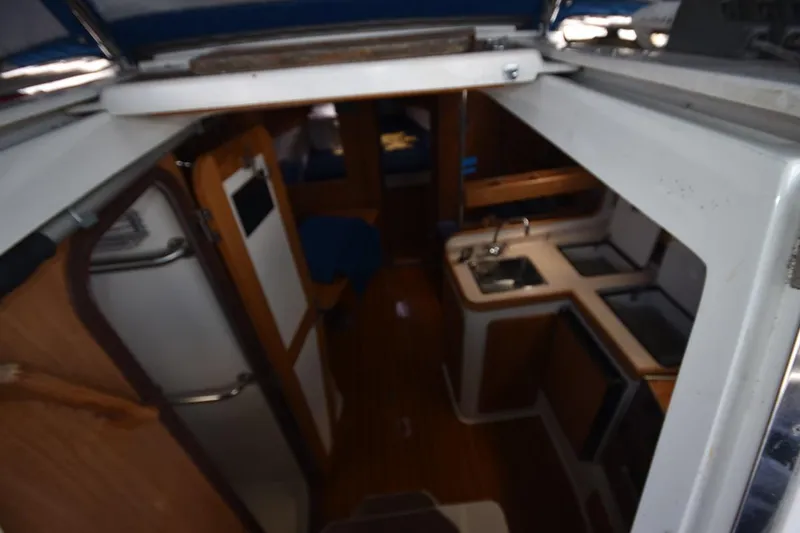 Slide: The Image of Interior view of a 2001 Catalina 310 sailboat, featuring a compact kitchen area. - 46