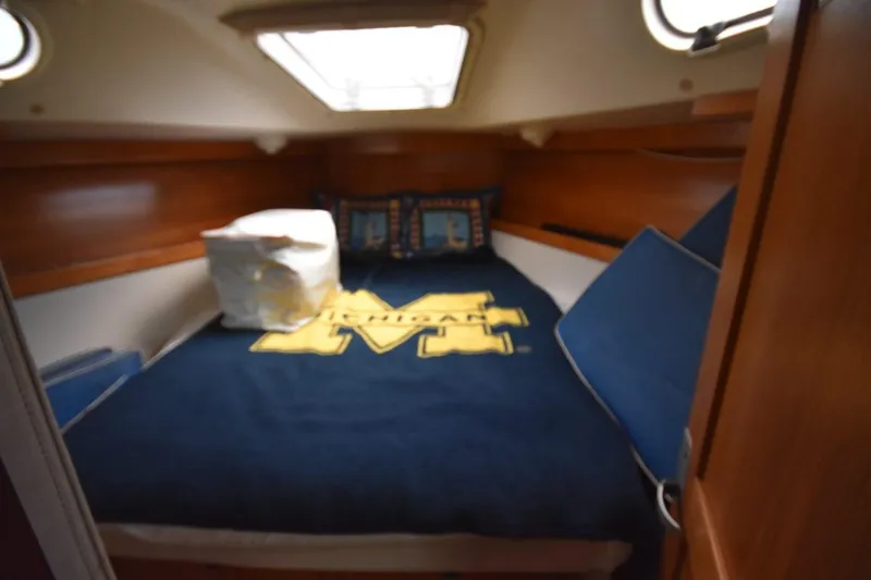 Slide: The Image of Cozy cabin interior of a 2001 Catalina 310 sailboat with nautical bedding. - 50