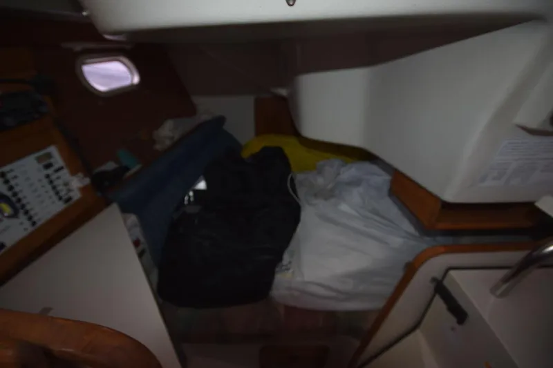 Slide: The Image of Interior cabin of a 2001 Catalina 310 sailboat with storage and seating area. - 60
