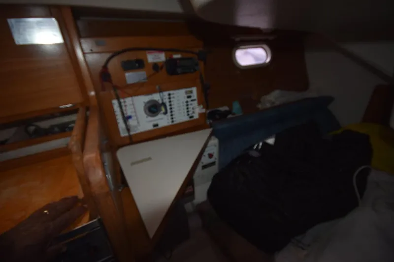 Slide: The Image of Interior of a 2001 Catalina 310 sailboat with navigation equipment and wooden cabinetry. - 61