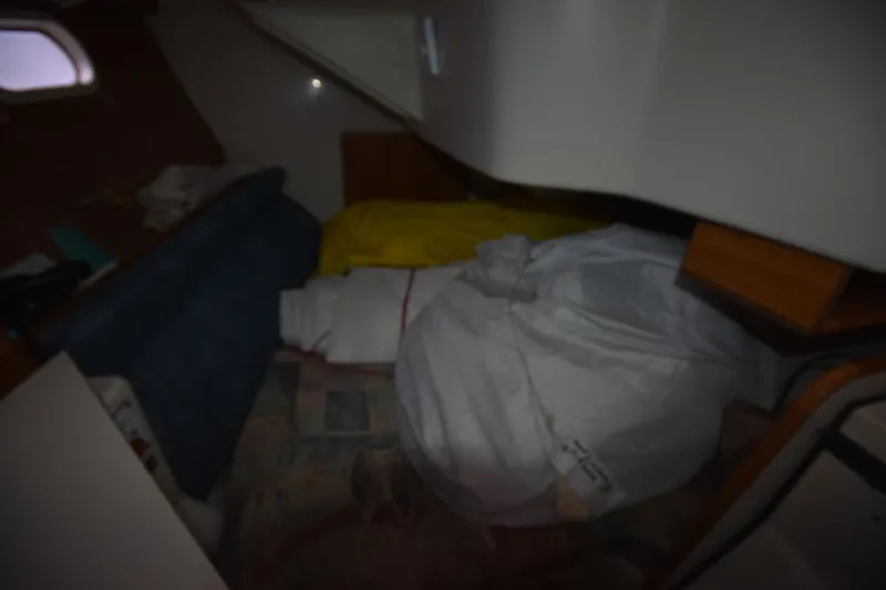 Slide: The Image of Interior of a 2001 Catalina 310 sailboat with stored sails and cushions. - 62