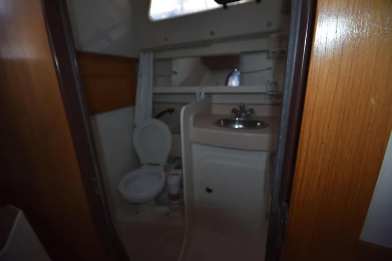 Slide: The Image of Bathroom interior of a 2001 Catalina 310 sailboat, featuring a toilet and sink. - 63