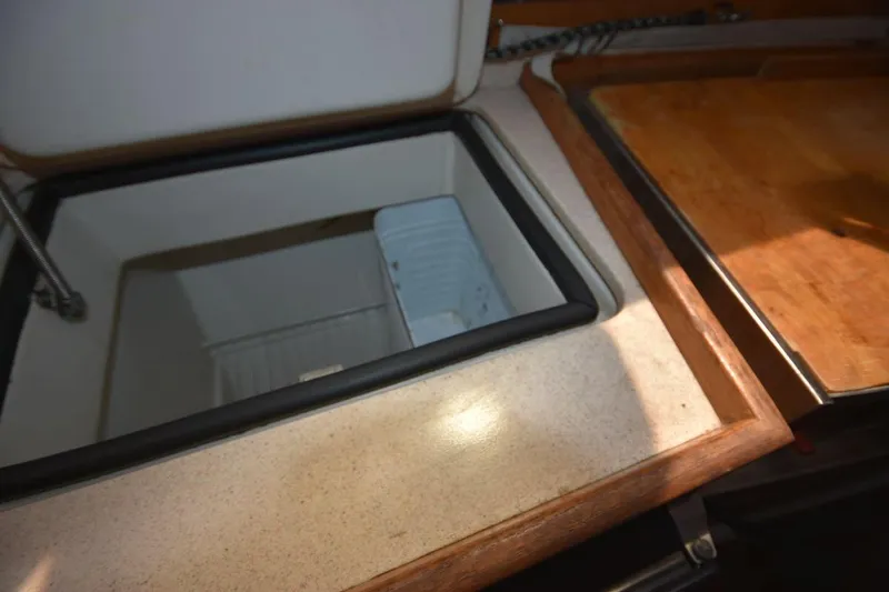 Slide: The Image of Open storage compartment in 2001 Catalina 310 sailboat galley. - 64