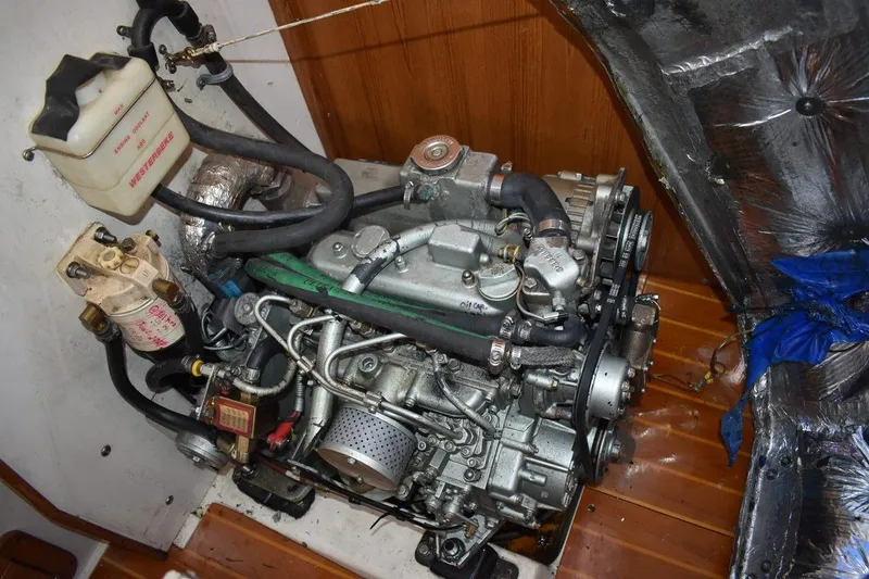 Slide: The Image of Engine compartment of a 2001 Catalina 310 sailboat, featuring a Westerbeke diesel engine. - 68