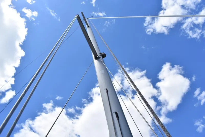Slide: The Image of Mast of 2001 Catalina 310 sailboat against a bright blue sky with clouds. - 69