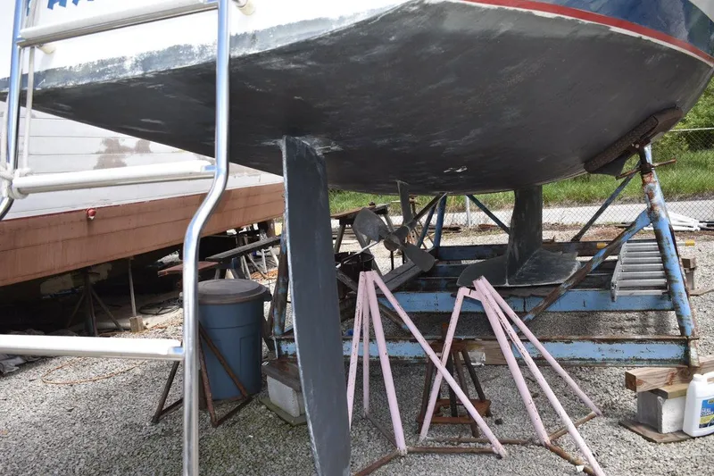 Slide: The Image of 2001 Catalina 310 sailboat on stands, showing keel and propeller in a boatyard. - 9