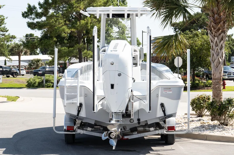 Slide: The Image of 2026 Blazer Bay Makaira 2600 boat on trailer, parked outdoors near palm trees. - 5