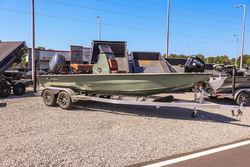 The Image of 2026 Avid 21 FSX boat on trailer, displayed outdoors in a dealership lot. - 1