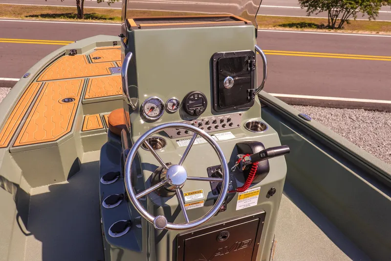 Slide: The Image of 2026 Avid 21 FSX boat console with steering wheel and control panel. - 11
