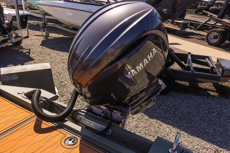 Slide: The Image of 2026 Avid 21 FSX boat with Yamaha outboard motor in a sunny outdoor setting. - 12