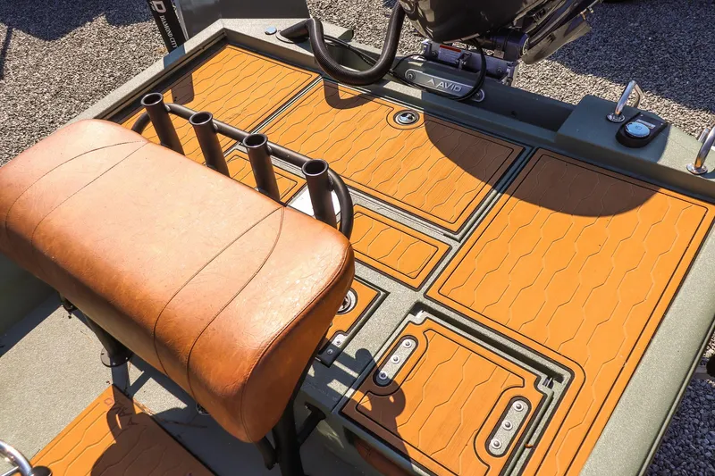 Slide: The Image of 2026 Avid 21 FSX boat interior with tan seating and rod holders. - 13