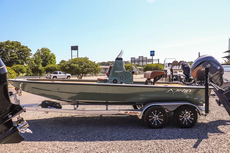 Slide: The Image of 2026 Avid 21 FSX boat on trailer, parked outdoors under clear sky. - 6