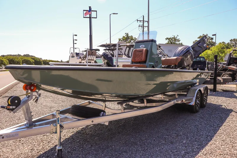 Slide: The Image of 2026 Avid 21 FSX boat on trailer, displayed outdoors under clear sky. - 7