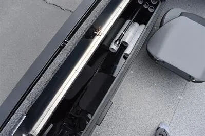 Slide: The Image of 2026 Lowe Fishing Machine 1675 WT rod storage compartment with organized fishing gear. - 14