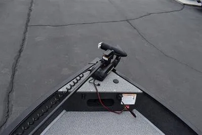 Slide: The Image of 2026 Lowe Fishing Machine 1675 WT boat deck with trolling motor on pavement. - 20