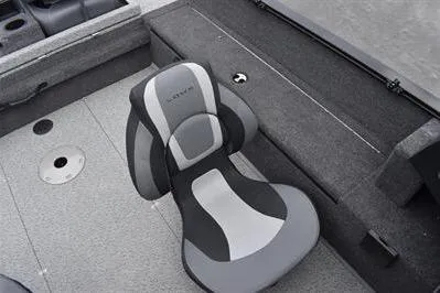 Slide: The Image of 2026 Lowe Fishing Machine 1675 WT interior with cushioned seat and storage compartments. - 22