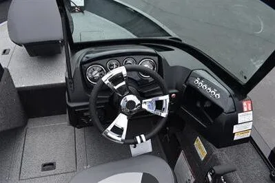 Slide: The Image of 2026 Lowe Fishing Machine 1675 WT dashboard with steering wheel and instrument panel. - 26