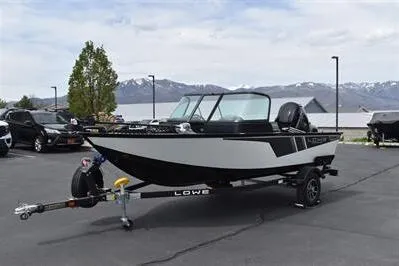 Slide: The Image of 2026 Lowe Fishing Machine 1675 WT boat on trailer, parked outdoors with mountain backdrop. - 3