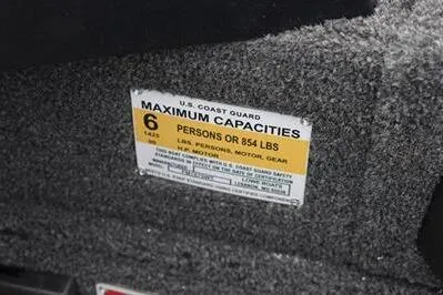 Slide: The Image of 2026 Lowe Fishing Machine 1675 WT capacity label, 6 persons or 854 lbs limit. - 32