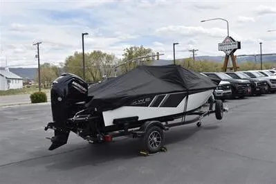 Slide: The Image of 2026 Lowe Fishing Machine 1675 WT boat with cover on trailer in parking lot. - 33