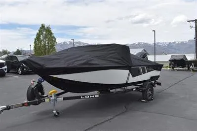 Slide: The Image of 2026 Lowe Fishing Machine 1675 WT boat covered on trailer, parked outdoors. - 36