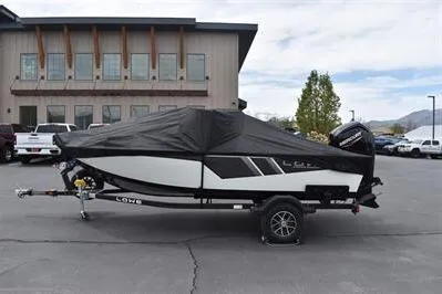 Slide: The Image of 2026 Lowe Fishing Machine 1675 WT boat, covered, parked outdoors. - 37