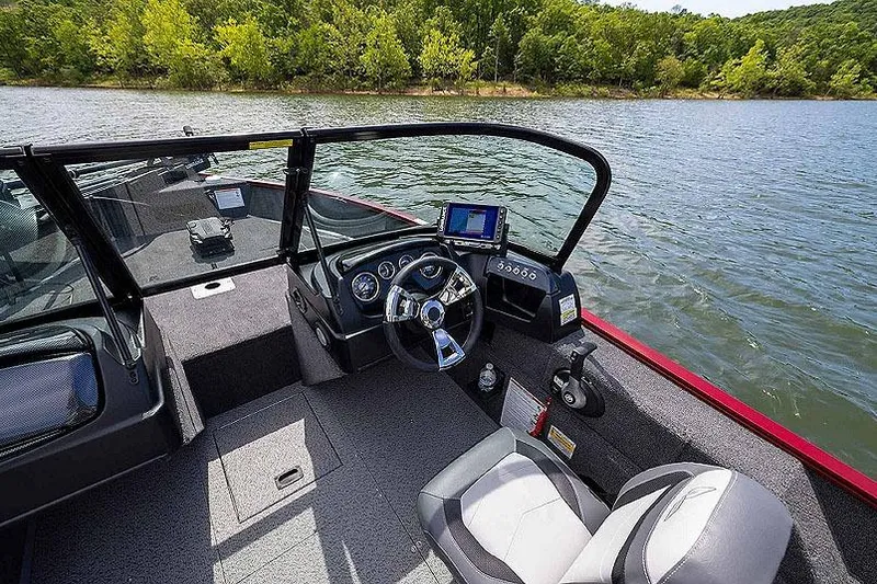 Slide: The Image of Manufacturer Provided Image: 2026 Lowe Fishing Machine 1675 WT boat interior with steering wheel and control panel on a lake. - 40