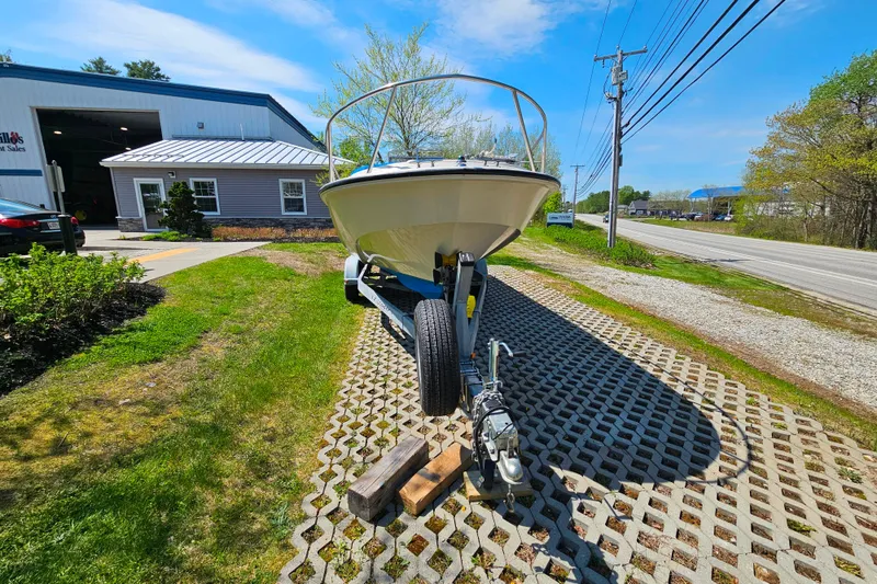 Slide: The Image of 1990 Boston Whaler OUTRAGE CUDDY boat on trailer outside a sales building. - 9