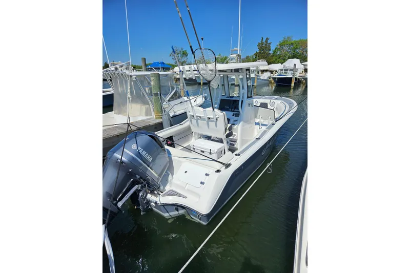 The Image of 2023 Tidewater boat with Yamaha engine docked at marina under clear blue sky. - 0